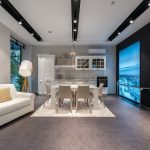Bright and stylish modern kitchen and living room with elegant furniture and decor.